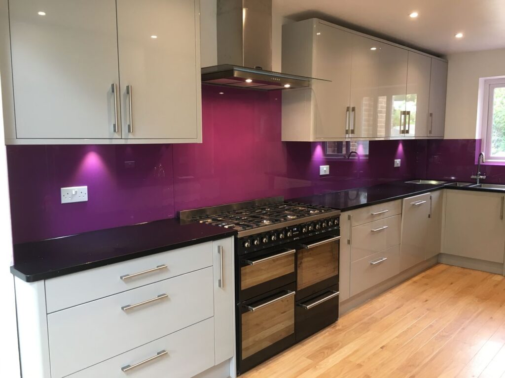 Epsom glass and glazing - an image of bespoke glass splashback (inverted T shape for hob range with back painted purple sparked design) produced and installed by Hamilton Glass Products Ltd
