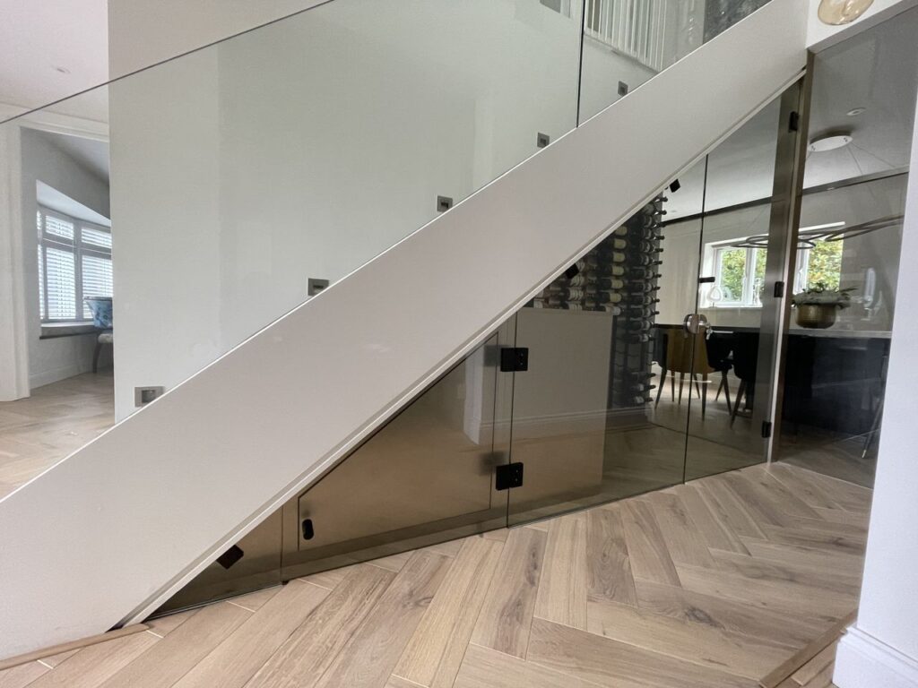Chesisngton glass and glazing - an image of a bespoke internal glass balustrade produced and installed by Hamilton Glass Products Ltd