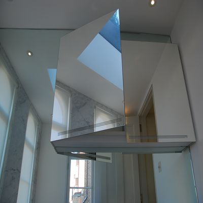 Quality bespoke mirrors - this image is of a a wall and wall cabinet cladded in mirrors