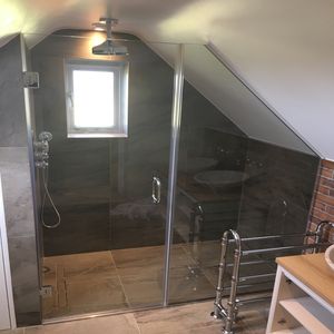 Bespoke Shower Glass - this images shows a bespoke glass shower enclosure in a loft extension